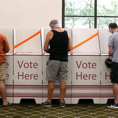 Men standing at Australian polling booths 